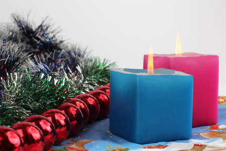 two burning candles with new year decorationの写真素材