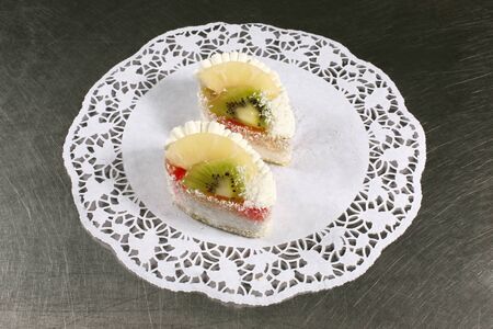 sweet cake with kiwi and pineapple on a gray backgroundの写真素材