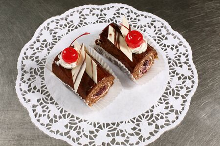 sweet chocolate cake with cherries on a gray backgroundの写真素材