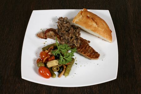 appetizer of grilled meat with mushrooms and vegetablesの写真素材