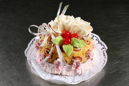 sweet white cake with cherries on a gray backgroundの写真素材