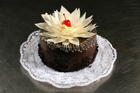 sweet chocolate cake with cherries on a gray backgroundの写真素材