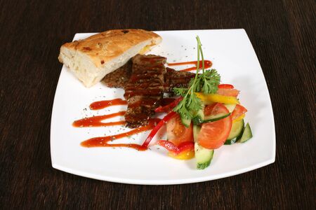 appetizer of grilled meat in sauce and vegetablesの写真素材