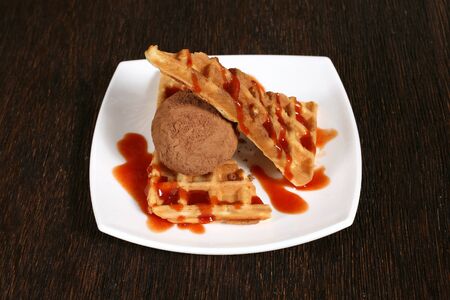 cakes with fruit jam and chocolate ice cream on white plateの写真素材