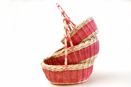 three decorative wicker baskets of various sizes from vines on a light backgroundの写真素材