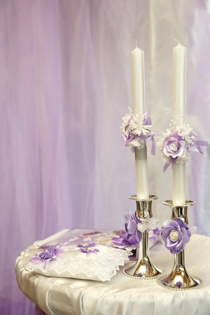 two decorated wedding candles beautiful on the tableの写真素材