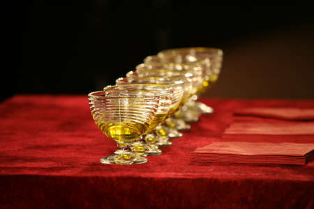 set of glass bowls of red liquid on the tableの写真素材