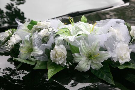 beautiful bouquet of ornamental flowers on the hood of the carの写真素材