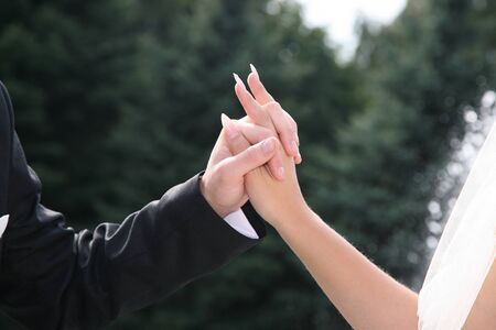 United hands of the bride and groom close upの写真素材