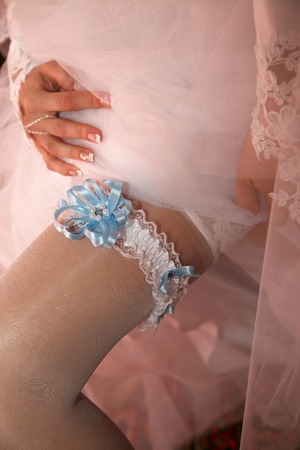 bride shows her wedding garterの写真素材