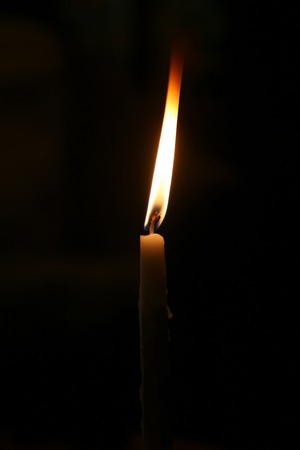 burning in the darkness small candleの写真素材