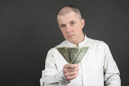 serious man offers three of the American dollarの写真素材