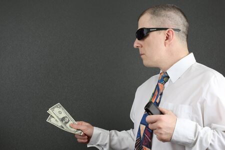 business man reaches out with dollarsの写真素材