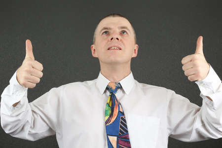 business man with thumbs raised hands looking upの写真素材