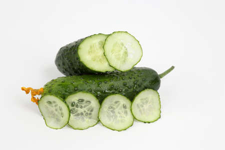 green sliced cucumber on white background