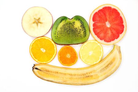 thin slicing different fruits on white background
