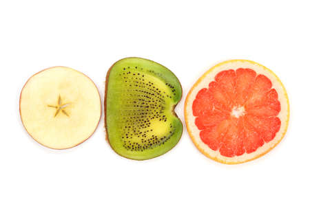 across sliced kiwi, apple and grapefruit on white backgroundの写真素材