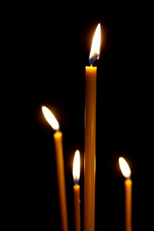 burning in the dark taper candlesの写真素材