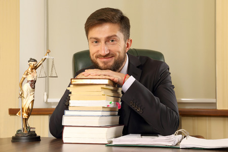 successful lawyer in office sitting at deskの写真素材