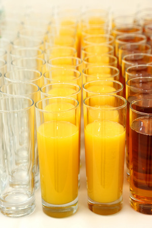 many glasses with different juiceの写真素材