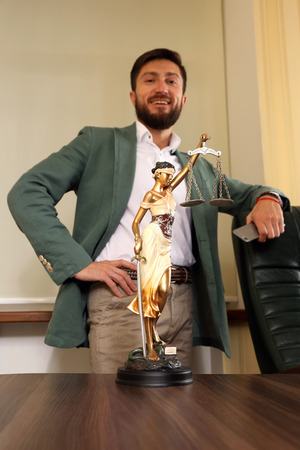 successful lawyer in the office with the symbol of justiceの写真素材