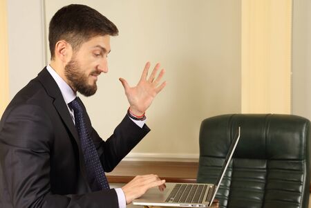 business man in emotion when working with a laptopの写真素材