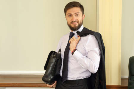 successful business man with a briefcase and suit in the handsの写真素材