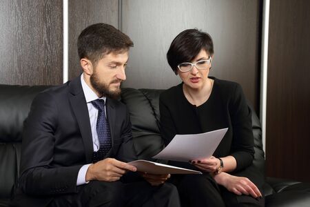 business partners in the office studying documentsの写真素材