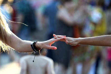 two hands in the drops of water join together