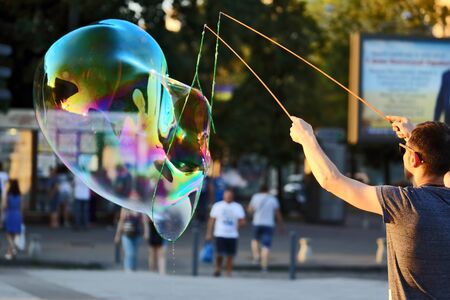 the man let a big bubble in the street