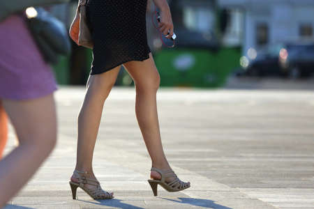 walking women legs in backlight sunlightの写真素材