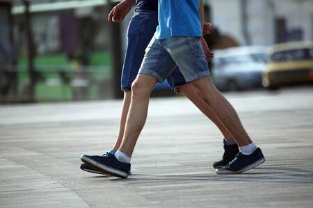 two pairs of feet walking together men