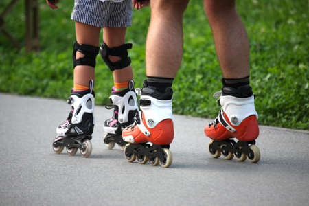 two pairs of legs on roller skates