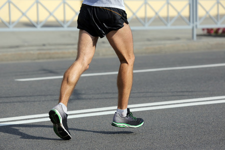 feet running athlete at the distance of a marathonの写真素材