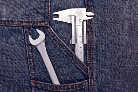 tools spanner and micrometer in jeans pocketの写真素材