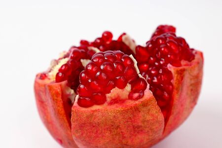 peeled pomegranate fruit closeup on white backgroundの写真素材