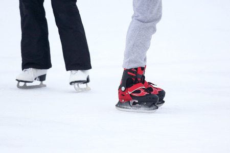 the legs of a man skating on an ice rink