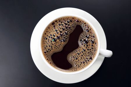 white cup of hot black coffee on dark backgroundの写真素材
