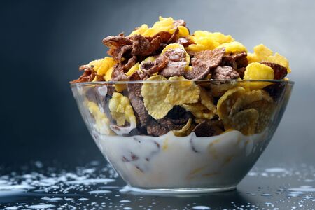 bowl of cornflakes filled with milkの写真素材