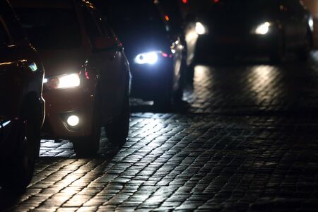 light cars go at night on the pavementの写真素材