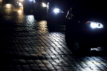 light cars go at night on the pavementの写真素材
