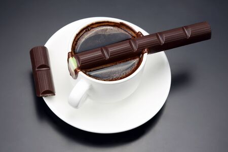 the chocolate melted on white hot Cup with black coffee
の写真素材