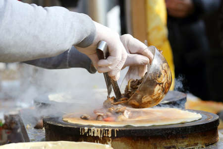 cooking pancakes stuffed with mushroomsの写真素材