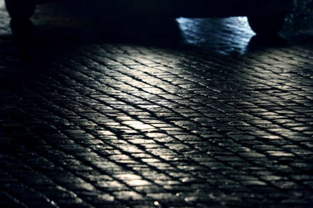 light cars go at night on the pavementの写真素材