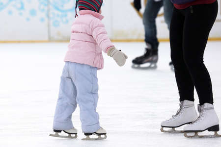 the girl helps the child to skateの写真素材