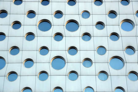 facade of a modern building with round windowsの写真素材