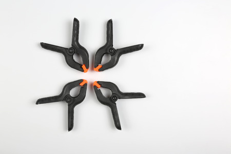 four black pegs on a white background