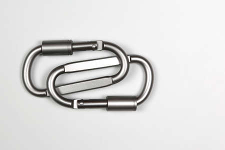 Two united grey climbing carabiner on a white backgroundの写真素材