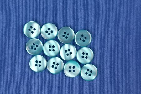 mother-of-pearl buttons on blue fabricの写真素材