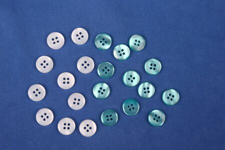 mother-of-pearl buttons on blue fabric
の写真素材